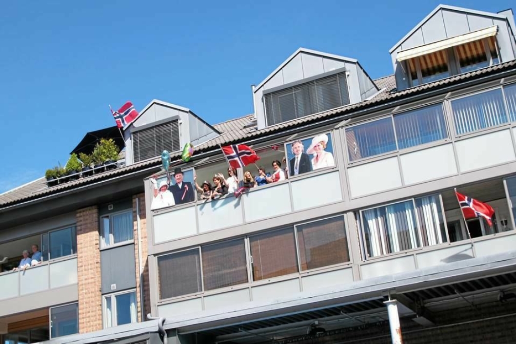HURRA: Her er Erik Aasen, kona Ingebjørg Ruud og resten av familien på balkongen i 3. etasje i Strandliveien 10 - med «besøk» av kongefamilien, som de har limt på utsiden av balkongen.